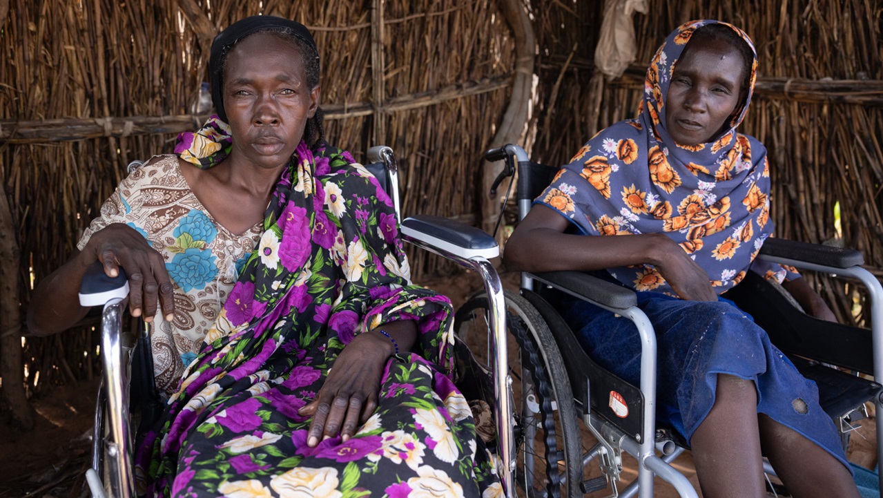 Kaltouma and Hassaneih Ismail Abdullah, two sisters, fled the conflict in the Darfur region of Sudan. Two disabled women in wheelchairs stare at the camera.
